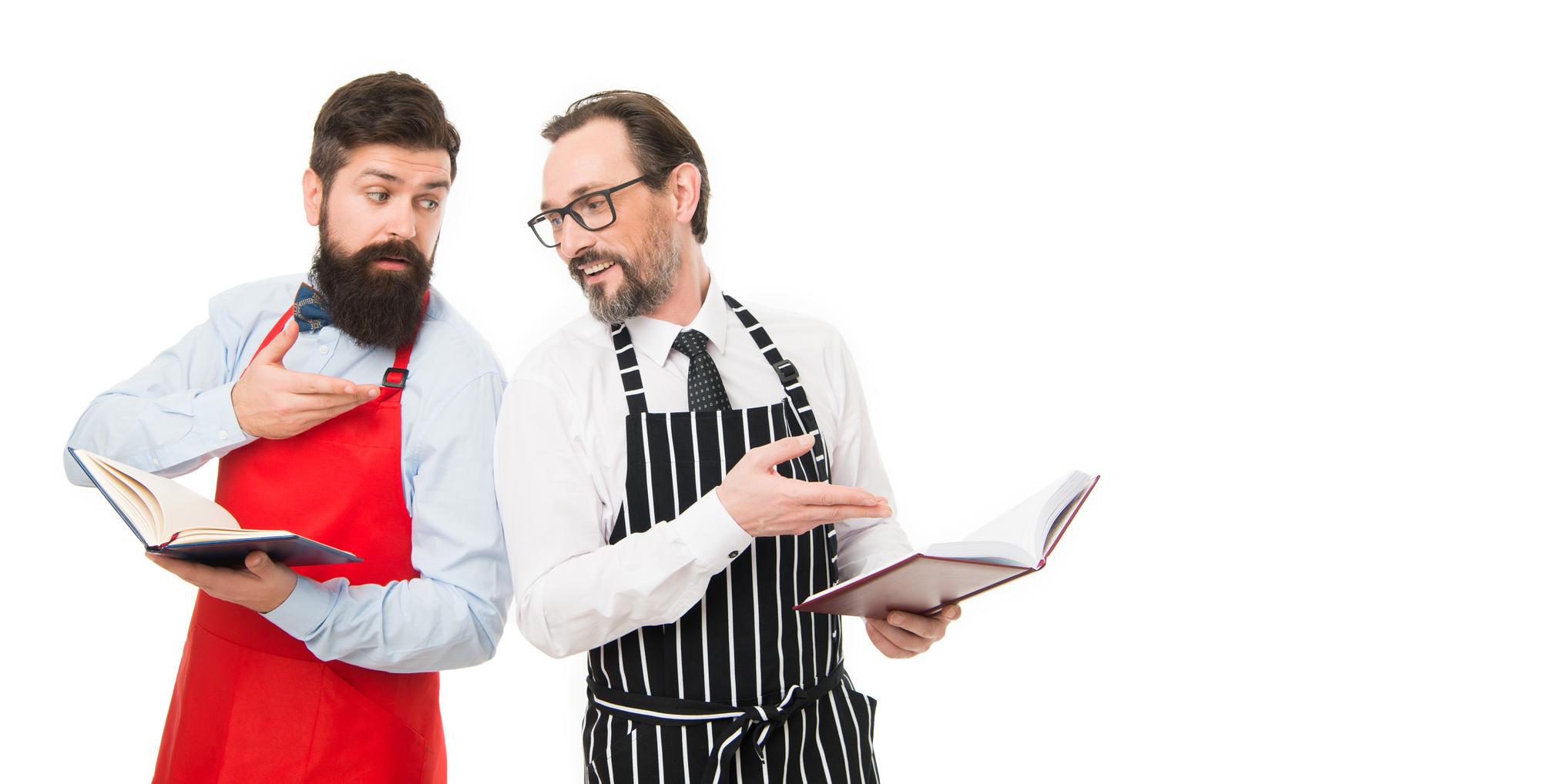 Chef consulting with restaurant owner over menu